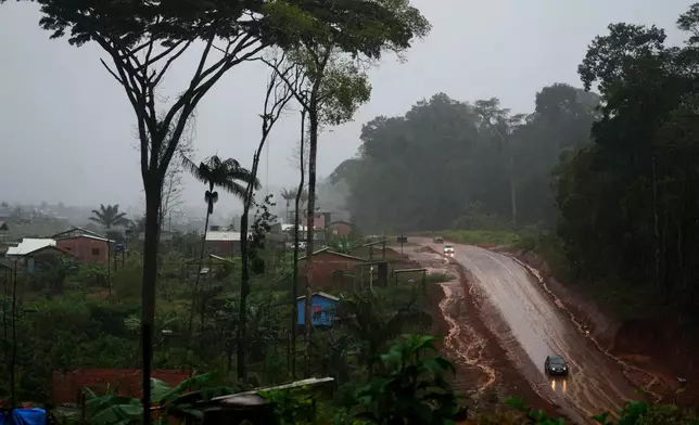 Vehicles move down a road in area known as Nova Conquista or New Conquest where families are building houses near the center of Oiapoque, Amapa state, Brazil, Wednesday, March 11, 2026. (AP Photo/Eraldo Peres)