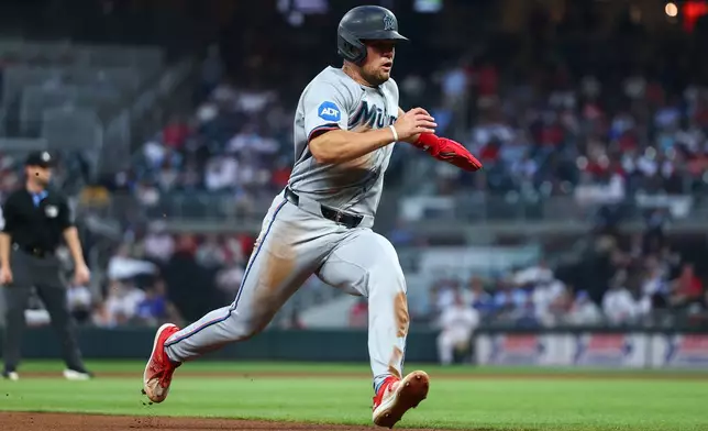 Miami Marlins' Jakob Marsee runs to third base in the fourth inning of a baseball game against the Atlanta Braves, Monday, April 13, 2026, in Atlanta. (AP Photo/Colin Hubbard)