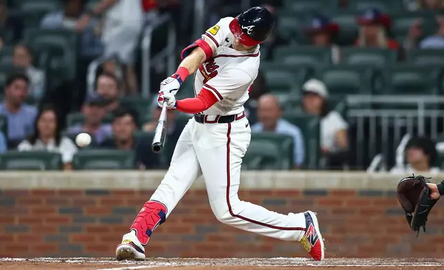 Atlanta Braves' Mike Yastrzemski hits an RBI single in the fourth inning of a baseball game against the Miami Marlins, Monday, April 13, 2026, in Atlanta. (AP Photo/Colin Hubbard)
