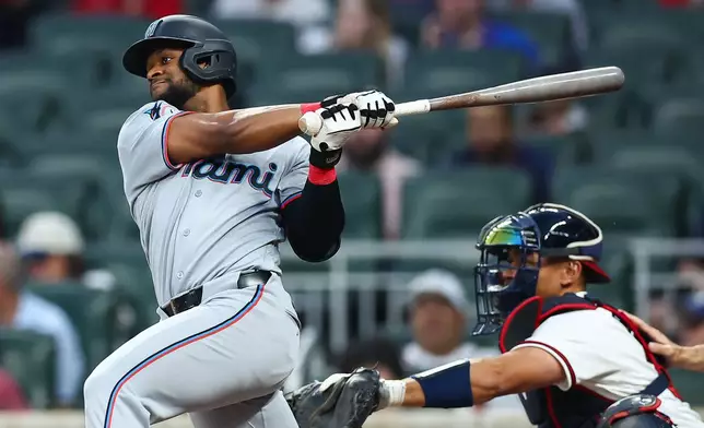 Miami Marlins' Otto Lopez hits an RBI single in the fourth inning of a baseball game against the Atlanta Braves, Monday, April 13, 2026, in Atlanta. (AP Photo/Colin Hubbard)