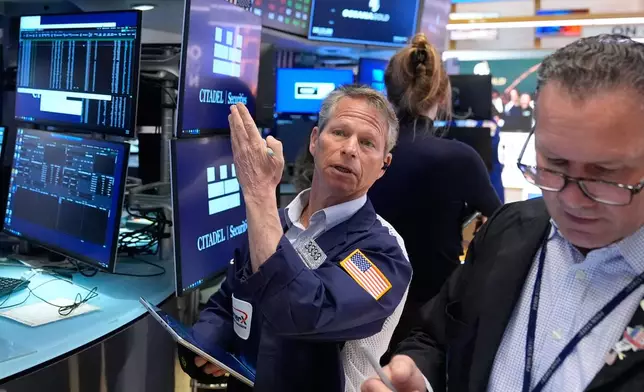Bobby Charmak works on the floor at the New York Stock Exchange in New York, Tuesday, April 7, 2026. (AP Photo/Seth Wenig)