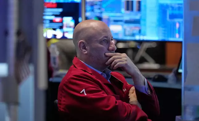 John Mauro works on the floor at the New York Stock Exchange in New York, Tuesday, April 7, 2026. (AP Photo/Seth Wenig)