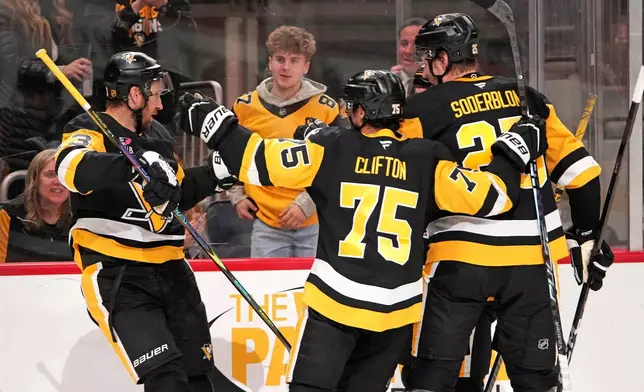 Pittsburgh Penguins' Kevin Hayes, left, celebrates his goal during the second period of an NHL hockey game against the Washington Capitals in Pittsburgh, Saturday, April 11, 2026. (AP Photo/Gene J. Puskar)