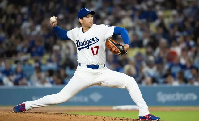 Los Angeles Dodgers starting pitcher Shohei Ohtani delivers during the second inning of a baseball game against the Cleveland Guardians in Los Angeles, Tuesday, March 31, 2026. (AP Photo/Kyusung Gong)