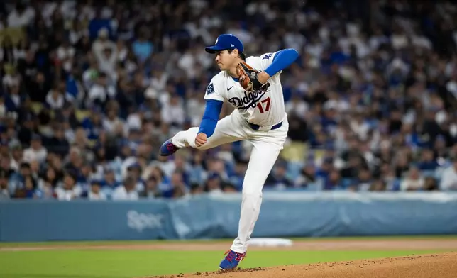 Los Angeles Dodgers starting pitcher Shohei Ohtani delivers during the first inning of a baseball game against the Cleveland Guardians in Los Angeles, Tuesday, March 31, 2026. (AP Photo/Kyusung Gong)