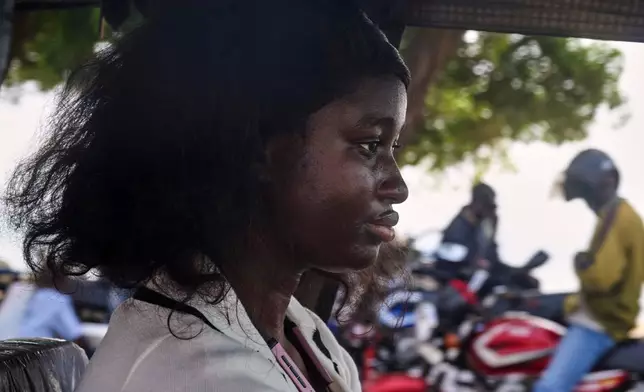 Halimatu Kamara, a rickshaw driver poses for a portrait in Freetown, Sierra Leone, March 7, 2026. (AP Photo/Abdul Hamid Kanu)