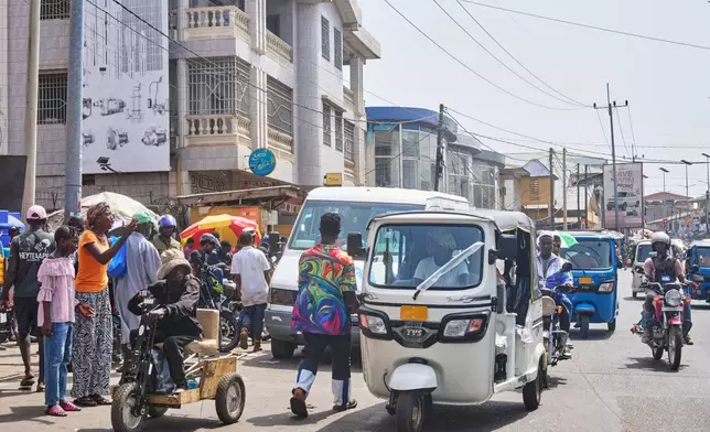 Hawa Mansaray transports a passenger in Freetown, Sierra Leone, March 7, 2026. (AP Photo/Abdul Hamid Kanu)