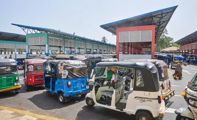 Commercial rickshaws drivers wait in line at a transport station in Freetown, Sierra Leone, March 7, 2026. (AP Photo/Abdul Hamid Kanu)