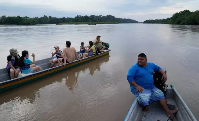 Carlos Diaz, a fisherman and tour guide, steers a tourist boat on a “hippo-watching” outing along the Magdalena River in Puerto Triunfo, Colombia, Wednesday, April 22, 2026. (AP Photo/Fernando Vergara)