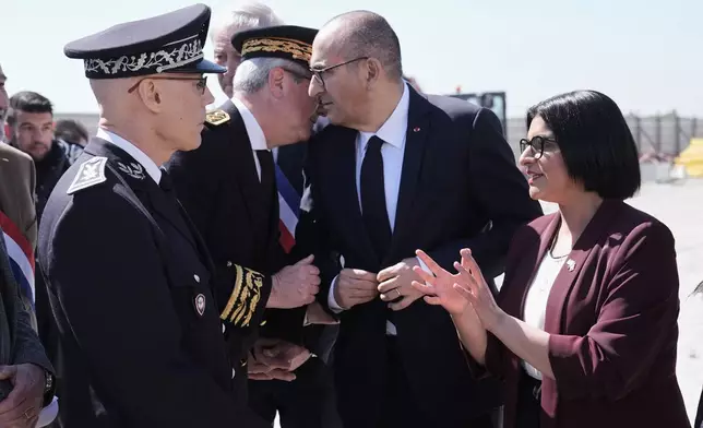 Britain's Home Secretary Shabana Mahmood, right, meets French police officers with France's Interior Minister Laurent Nunez on the site of a new detention centre that is being built in Dunkirk, France, Thursday April 23, 2026. (Stefan Rousseau/Pool Photo via AP)