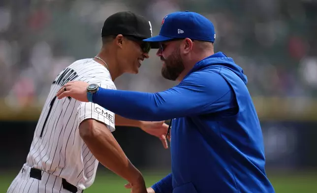 Chicago White Sox manager Will Venable, left, and Toronto Blue Jays manager John Schneider greet each other before a home-opening baseball game Friday, April 3, 2026, in Chicago. (AP Photo/Erin Hooley)