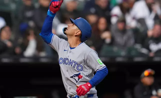Toronto Blue Jays' Andrés Giménez runs the bases after hitting a two-run home run during the eighth inning of a home-opener baseball game against the Chicago White Sox, Friday, April 3, 2026, in Chicago. (AP Photo/Erin Hooley)