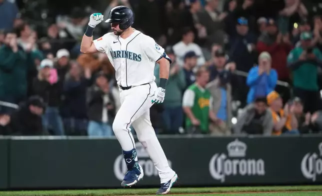 Seattle Mariners designated hitter Cal Raleigh jogs home after hitting a solo home run against the Athletics during the fifth inningof a baseball game, Tuesday, April 21, 2026, in Seattle. (AP Photo/Lindsey Wasson)
