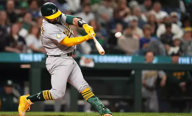 Athletics' Shea Langeliers hits a solo home run against the Seattle Mariners during the sixth inning of a baseball game, Monday, April 20, 2026, in Seattle. (AP Photo/Lindsey Wasson)