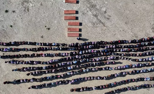 FILE - Mourners pray over the six coffins of members of the Al-Jalib family, who were killed Wednesday in Israeli strikes in Beirut, during their funeral in the village of al-Sour, Deir al-Zour province, northeastern Syria, Saturday, April 11, 2026. (AP Photo/Ghaith Alsayed, File)
