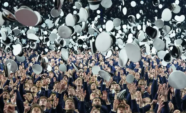 FILE - New young German police officer trainees throw their hats in the air after taking their oath of service and officially entering the service for security, law and democracy in Cologne, Germany, Wednesday, April 15, 2026. (AP Photo/Martin Meissner, FIle)