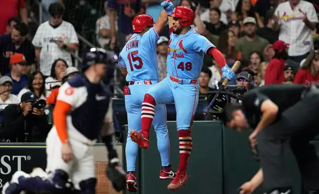 St. Louis Cardinals' José Fermín (15) celebrates with Iván Herrera after hitting a home run during the sixth inning of a baseball game Houston Astros in Houston, Saturday, April 18, 2026. (AP Photo/Ashley Landis)