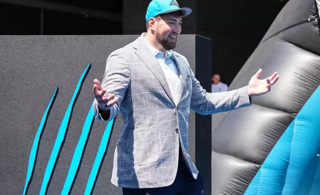 Monroe Freeling, selected in the first round of the NFL football draft by the Carolina Panthers, takes part in a welcome ceremony, Friday, April 24, 2026, in Charlotte, N.C. (AP Photo/Matt Kelley)