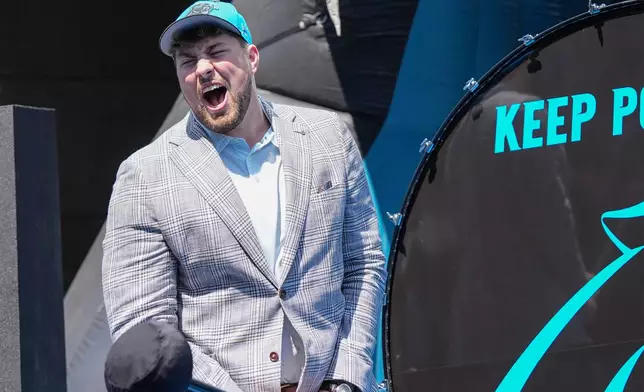 Monroe Freeling, selected in the first round of the NFL football draft by the Carolina Panthers, takes part in a welcome ceremony, Friday, April 24, 2026, in Charlotte, N.C. (AP Photo/Matt Kelley)