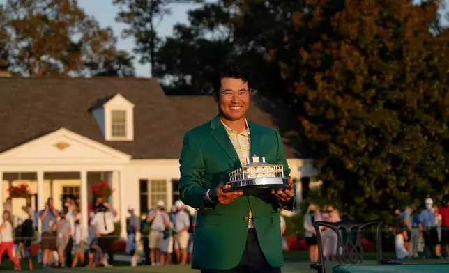 FILE - Hideki Matsuyama, of Japan, holds the winner's trophy after winning the Masters golf tournament Sunday, April 11, 2021, in Augusta, Ga. (AP Photo/David J. Phillip, File)