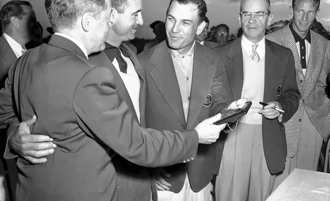 FILE - Ben Hogan, third from left, of Fort Worth, Texas, receives his plaque for winning the Masters golf tournament from Bobby Jones, left, in Augusta, Ga. on April 8, 1951. Others are: Skee Riegel, runner up; Cliff Roberts, tournament chairman; and Charles Coe, low amateur. (AP Photo/Horace Cort, File)