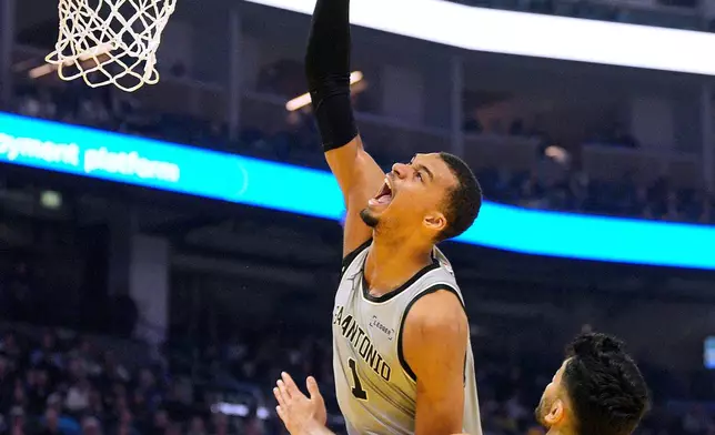 San Antonio Spurs forward Victor Wembanyama (1) reacts as he is fouled by Golden State Warriors center Omer Yurtseven (77) during the first half of an NBA basketball game in San Francisco, Wednesday, April 1, 2026. (AP Photo/Tony Avelar)