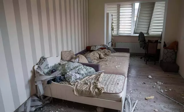 Broken glass is seen on beds at an which was damaged after a Russian strike on residential neighbourhood in Kriukivshchyna, Kyiv region, Ukraine, on Friday, April 3, 2026. (AP Photo/Evgeniy Maloletka)