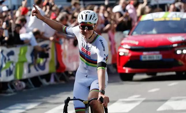 Slovenia's Tadej Pogacar of the UAE Team Emirates crosses the finish line to win the Belgian cycling classic and UCI World Tour race Liege Bastogne Liege, in Liege, Belgium, Sunday, April 26, 2026. (AP Photo/Geert Vanden Wijngaert)
