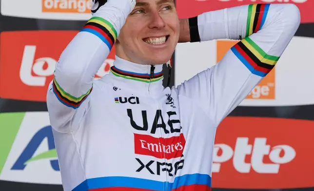 First place, Slovenia's Tadej Pogacar of the UAE Team Emirates celebrates on the podium during the Belgian cycling classic and UCI World Tour race Liege Bastogne Liege, in Liege, Belgium, Sunday, April 26, 2026. (AP Photo/Geert Vanden Wijngaert)