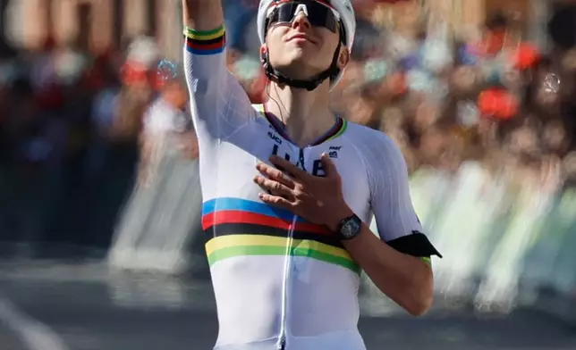 Slovenia's Tadej Pogacar of the UAE Team Emirates crosses the finish line to win the Belgian cycling classic and UCI World Tour race Liege Bastogne Liege, in Liege, Belgium, Sunday, April 26, 2026. (AP Photo/Geert Vanden Wijngaert)