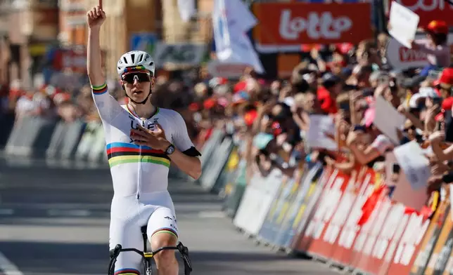Slovenia's Tadej Pogacar of the UAE Team Emirates crosses the finish line to win the Belgian cycling classic and UCI World Tour race Liege Bastogne Liege, in Liege, Belgium, Sunday, April 26, 2026. (AP Photo/Geert Vanden Wijngaert)