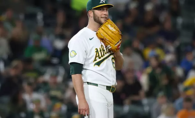Athletics pitcher Justin Sterner reacts after a bunt single by Kansas City Royals Kyle Isbel during the 10th inning of a baseball game Tuesday, April 28, 2026, in West Sacramento, Calif. (AP Photo/Scott Marshall)