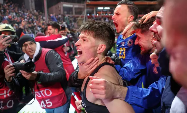 Bosnia's Esmir Bajraktarevic celebrates after winning a penalty shootout during the World Cup qualifying playoff final soccer match between Bosnia and Italy in Zenica, Bosnia, Tuesday, March 31, 2026. (AP Photo/Armin Durgut)