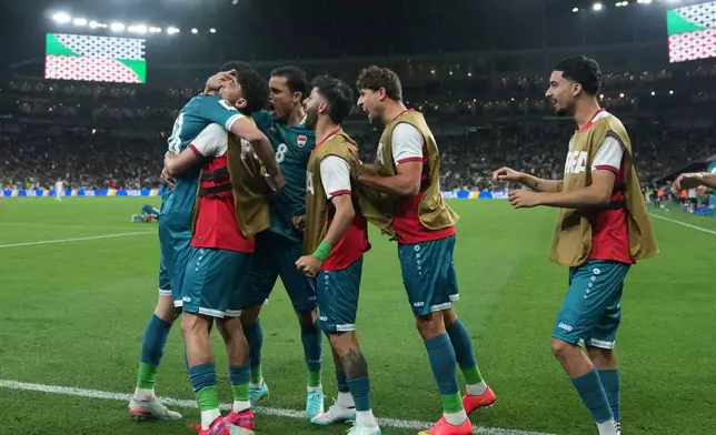 Iraq's Aymen Hussein, left, is congratulated after scoring his side's 2nd goal during the World Cup playoff final soccer match between Iraq and Bolivia in Monterrey, Mexico, Tuesday, March 31, 2026. (AP Photo/Fernando Llano)