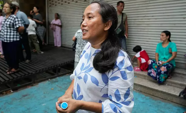 Filmmaker Shin Daewe talks to journalists after she was released from Insein Prison in Yangon, Myanmar, Friday, April 17, 2026, following Myanmar President's amnesty to mark the country's traditional new year. (AP Photo/Thein Zaw)