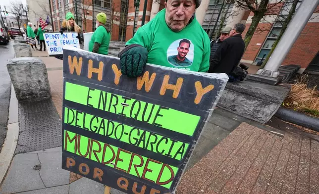 Rod Cleveland, of Middleborough, Mass., a supporter of victim Enrique Delgado-Garcia, pickets outside Worcester County Superior Court where three Mass. State Police officers were arraigned on charges of involuntary manslaughter, Thursday, April 2, 2026, in Worcester, Mass. (AP Photo/Charles Krupa)