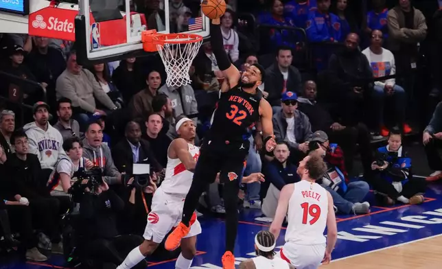 New York Knicks center Karl-Anthony Towns (32) dunks during the first half of an NBA basketball game against Toronto Raptors, Friday, April 10, 2026, in New York. (AP Photo/Yuki Iwamura)