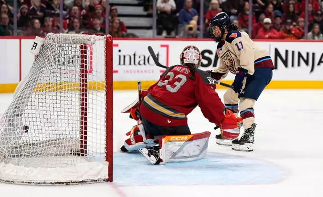 Montreal Victoire's Abby Roque (11) scores against Ottawa Charge goaltender Gwyneth Philips (33) during second-period PWHL hockey game action in Ottawa, Ontario, Friday, April 3, 2026. (Justin Tang/The Canadian Press via AP)