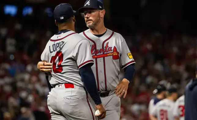 Atlanta Braves pitcher Reynaldo López (40) is held back after a fight broke out during the fifth inning of a baseball game between the Los Angeles Angels and the Atlanta Braves, Tuesday, April 7, 2026, in Anaheim, Calif. (AP Photo/Ethan Swope)