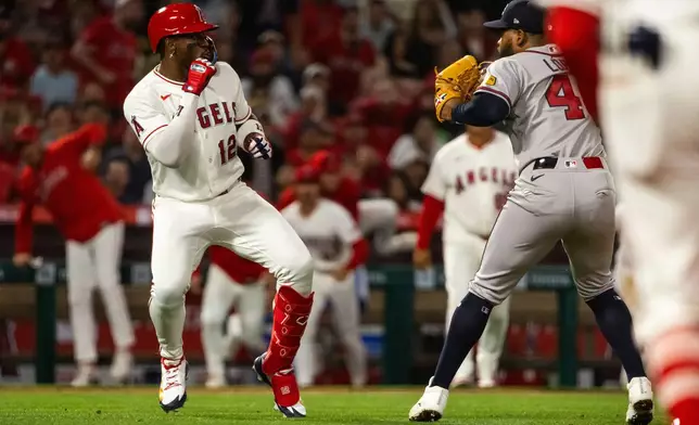 A fight breaks out during the fifth inning of a baseball game between the Los Angeles Angels and the Atlanta Braves, Tuesday, April 7, 2026, in Anaheim, Calif. (AP Photo/Ethan Swope)