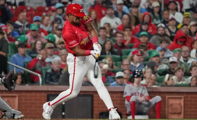 St. Louis Cardinals' Jose Fermin hits a sacrifice fly to score Ramon Urias during the fifth inning of a baseball game against the Boston Red Sox Friday, April 10, 2026, in St. Louis. (AP Photo/Jeff Roberson)