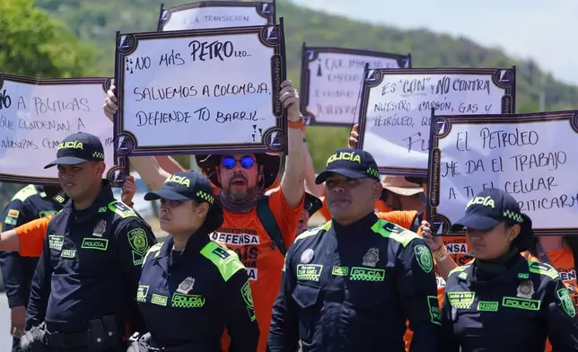 Activists participate in a pro-oil demonstration and against President Gustavo Petro, of Colombia, outside of a conference aimed at transitioning away from fossil fuels Tuesday, April 28, 2026, in Santa Marta, Colombia. (AP Photo/Ivan Valencia)