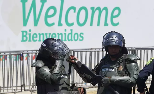 Security personnel work outside of a conference aimed at transitioning away from fossil fuels Tuesday, April 28, 2026, in Santa Marta, Colombia. (AP Photo/Ivan Valencia)