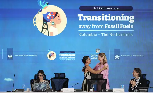 Stientje van Veldhoven, Minister of Climate Policy and Green Growth of the Netherlands, right, embraces Colombia's Environmental Minister Irene Vélez Torres during a conference aimed at transitioning away from fossil fuels Tuesday, April 28, 2026, in Santa Marta, Colombia. (AP Photo/Ivan Valencia)