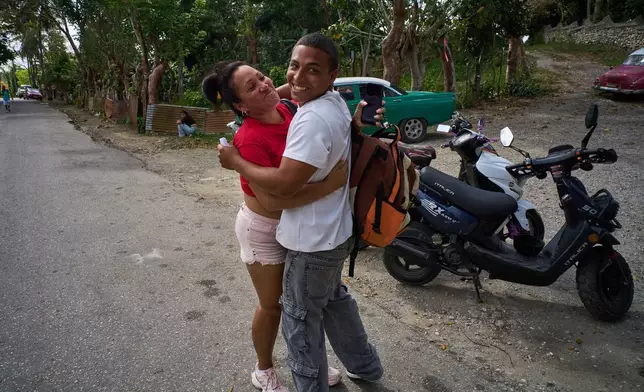 Emilio Alejandro Leyva, a pardoned prisoner, right, hugs his mother Katia Arias Mendoza after his release from La Lima penitentiary in Guanabo, Cuba, Friday, April 3, 2026. (AP Photo/Ramon Espinosa)
