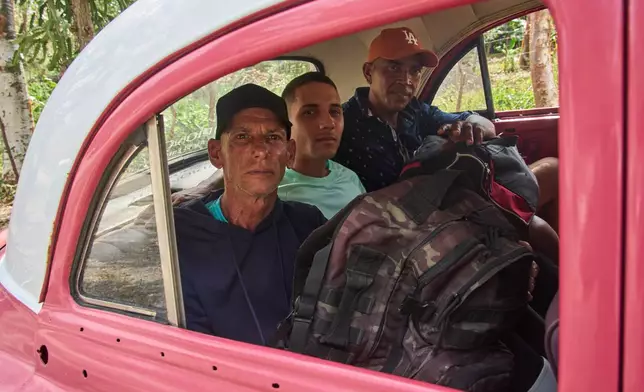 Pardoned prisoners sit in a taxi to return home after leaving La Lima penitentiary in Guanabo, Cuba, Friday, April 3, 2026. (AP Photo/Ramon Espinosa)