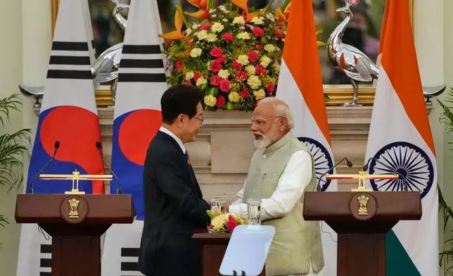 India Prime Minister Narendra Modi shakes hand with South Korean President Lee Jae Myung, left, after the signing of memorandum of understanding and agreements between their countries in New Delhi, India, Monday, April 20, 2026. (AP Photo/Manish Swarup)