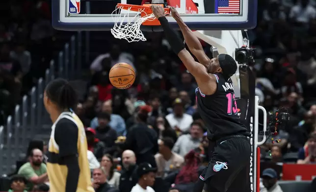 Miami Heat center Bam Adebayo, right, dunks during the first half of an NBA basketball game against the Washington Wizards, Friday, April 10, 2026, in Washington. (AP Photo/Terrance Williams)