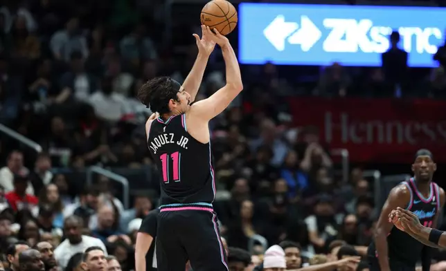 Miami Heat forward Jaime Jaquez Jr. (11) shoots a 3-point basket during the first half of an NBA basketball game against the Washington Wizards, Friday, April 10, 2026, in Washington. (AP Photo/Terrance Williams)