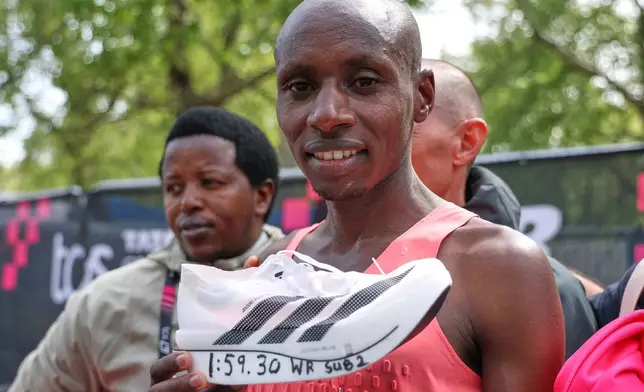 Sebastian Sawe from Kenya celebrates winning the men's race at the London Marathon in London, Sunday, April 26, 2026.(AP Photo/Ian Walton)